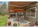 Outdoor patio featuring a dining table, seating, umbrella, and hot tub in the backyard at 9251 Sand Hill Trl, Highlands Ranch, CO 80126