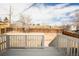 Spacious backyard with wood fence, patio, and white railing deck at 441 Elbert Way, Denver, CO 80221