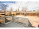 Spacious backyard with wood fence, patio, and white railing deck at 441 Elbert Way, Denver, CO 80221