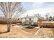 Aerial shot of a spacious backyard with a deck, concrete patio, partial privacy fence, and some gardening area at 441 Elbert Way, Denver, CO 80221