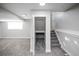 Spacious finished basement featuring neutral tones, a window, and a carpeted staircase leading to the upper level at 441 Elbert Way, Denver, CO 80221