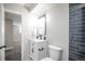 Modern bathroom featuring a vanity, with black fixtures, toilet, and tasteful accent tile at 441 Elbert Way, Denver, CO 80221