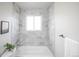 Bright bathroom features marble tiling, modern fixtures, and lots of natural light at 441 Elbert Way, Denver, CO 80221