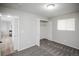 Comfortable carpeted bedroom featuring large window and an open closet at 441 Elbert Way, Denver, CO 80221