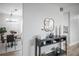 Stylish entryway with modern decor, decorative mirror, console table, and view of dining area at 441 Elbert Way, Denver, CO 80221