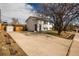 Front exterior showcasing a well-maintained lawn, driveway, mature tree, and charming curb appeal at 441 Elbert Way, Denver, CO 80221