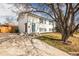 Front exterior features a well-manicured lawn and mature tree framing the home and inviting curb appeal at 441 Elbert Way, Denver, CO 80221