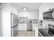 Modern kitchen with white cabinets, stainless steel appliances, and granite countertops at 441 Elbert Way, Denver, CO 80221