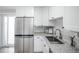 Modern kitchen area with stainless steel appliances, granite countertops, and stylish sink at 441 Elbert Way, Denver, CO 80221