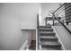 Modern staircase features gray carpeting, contrasting dark railings, and leads to the upper level at 441 Elbert Way, Denver, CO 80221