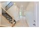Bright foyer with wood-look floors and carpeted stairs, leading to the upper level at 812 Mulberry St, Louisville, CO 80027