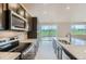 Well-appointed kitchen featuring modern appliances, granite countertops, and sliding glass doors with scenic views at 812 Mulberry St, Louisville, CO 80027