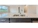 Close-up on a granite kitchen island with a stainless steel sink and sleek cabinetry in a modern design at 812 Mulberry St, Louisville, CO 80027