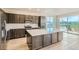 Modern kitchen with a large island, stainless steel appliances, and a window view to the outdoor landscape at 812 Mulberry St, Louisville, CO 80027