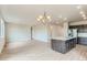 Open-concept living room and kitchen area with modern lighting, stainless steel appliances, and center island at 812 Mulberry St, Louisville, CO 80027