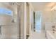 Modern shower with glass door and sleek fixtures, complemented by neutral tile at 812 Mulberry St, Louisville, CO 80027