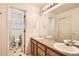 Bright bathroom boasts dual sinks and a large mirror at 14045 E Grand Ave, Aurora, CO 80015