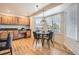 Cozy dining area with hardwood floors, a round table, and natural light from large windows at 14045 E Grand Ave, Aurora, CO 80015