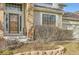 Inviting front entrance of a well-maintained home, featuring brick accents and mature landscaping at 14045 E Grand Ave, Aurora, CO 80015