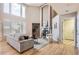 Bright living room with a vaulted ceiling, fireplace, and large windows overlooking the deck at 14045 E Grand Ave, Aurora, CO 80015