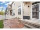 A private back patio has stone pavers, a white fence, and access to the home's back door at 1473 Red Cliff Way, Castle Rock, CO 80109