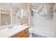 Full bathroom with tub/shower combo, wood vanity, and built-in storage at 1473 Red Cliff Way, Castle Rock, CO 80109
