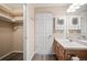 Bathroom with wood vanity, storage cabinet and mirror, featuring luxury vinyl floors at 1473 Red Cliff Way, Castle Rock, CO 80109