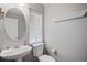 Bathroom features a pedestal sink, toilet, and window with a bright neutral color palette at 1473 Red Cliff Way, Castle Rock, CO 80109