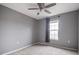 Bedroom with plush carpet, ceiling fan, and a large window at 1473 Red Cliff Way, Castle Rock, CO 80109