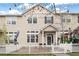 Charming two-story townhome with a well-kept front yard and a classic white picket fence at 1473 Red Cliff Way, Castle Rock, CO 80109