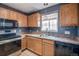Well-lit kitchen features stainless steel appliances, wood cabinets, and a stainless steel sink at 1473 Red Cliff Way, Castle Rock, CO 80109