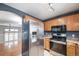 Modern kitchen with stainless steel appliances and view into adjacent dining room at 1473 Red Cliff Way, Castle Rock, CO 80109