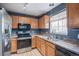 Well-equipped kitchen featuring stainless steel appliances and wood cabinetry at 1473 Red Cliff Way, Castle Rock, CO 80109