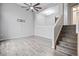 Spacious living room with modern gray floors and access to an open staircase at 1473 Red Cliff Way, Castle Rock, CO 80109