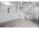 An open living room features hard surface floors, a ceiling fan and a staircase at 1473 Red Cliff Way, Castle Rock, CO 80109