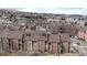 Aerial view of condominium complex showcasing brick facade, landscaping, and surrounding neighborhood at 12368 W Nevada Pl # 303, Lakewood, CO 80228