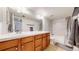 Well-lit bathroom includes a double vanity, white tiled walls, and a shower-tub combination at 12368 W Nevada Pl # 303, Lakewood, CO 80228