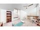 Bright bonus room with large windows, built-in shelving, and modern ceiling fan at 12368 W Nevada Pl # 303, Lakewood, CO 80228