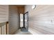 Exterior condo entrance with a black security door and wood siding at 12368 W Nevada Pl # 303, Lakewood, CO 80228