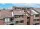 Exterior view of a multi-story condo building with balconies and well-maintained landscaping on a sunny day at 12368 W Nevada Pl # 303, Lakewood, CO 80228