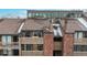 Three-story condominium complex with wood facade, brick accents, and upper clerestory windows at 12368 W Nevada Pl # 303, Lakewood, CO 80228
