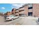Exterior of multilevel condo with a parking lot and stairs to the unit at 12368 W Nevada Pl # 303, Lakewood, CO 80228