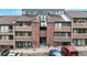 Exterior of a multi-level condo complex with brick accents and reserved parking at 12368 W Nevada Pl # 303, Lakewood, CO 80228