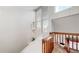 Hallway with a wooden railing, a bright window and a unique pendant light fixture at 12368 W Nevada Pl # 303, Lakewood, CO 80228