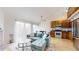 Inviting open-concept living room with a comfortable sectional couch, modern kitchen, and dining area at 12368 W Nevada Pl # 303, Lakewood, CO 80228