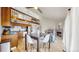Open-concept living space featuring a modern kitchen, dining area, and cozy living room with a fireplace at 12368 W Nevada Pl # 303, Lakewood, CO 80228