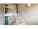Exterior staircase leading to an upper-level condo with beige wood siding at 12368 W Nevada Pl # 303, Lakewood, CO 80228