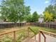 Tranquil backyard view featuring a wooden fence and mature trees at 298 S Hoover Ave, Louisville, CO 80027