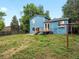Expansive backyard with a wooden deck, mature trees, and a well-maintained lawn at 298 S Hoover Ave, Louisville, CO 80027
