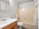 Bathroom featuring a shower-tub combo with neutral tile and classic vanity at 298 S Hoover Ave, Louisville, CO 80027